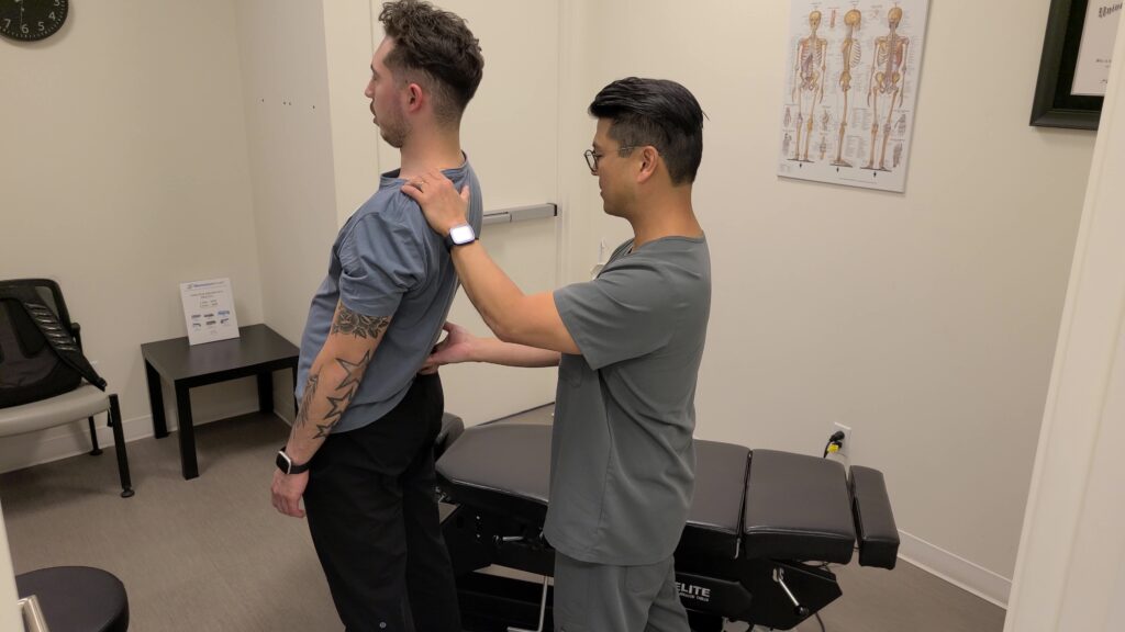 Dr Brad Fujimoto, Chiropractor, examining a patient