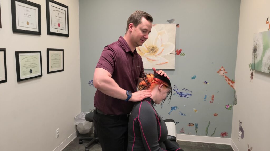 Dr. Colin, chiropractor, working on a neck