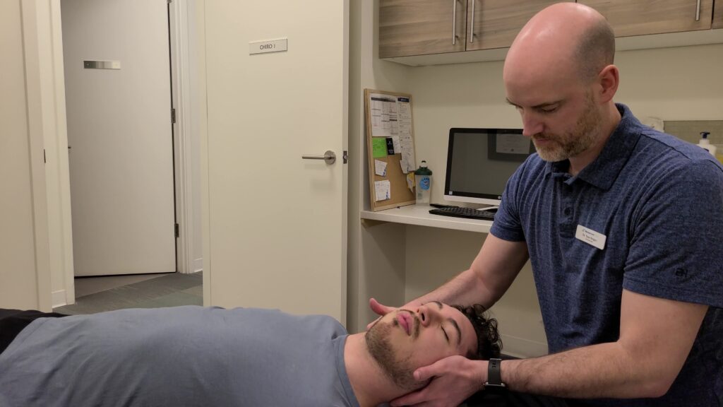 Dr Teac at Momentum Health Seton works on a neck