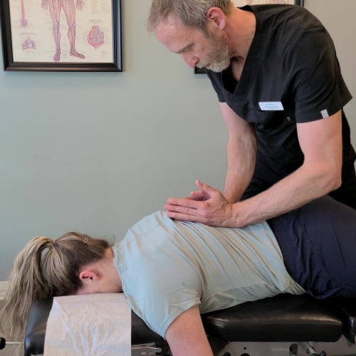 Dr Denis providing a chiropractic adjustment